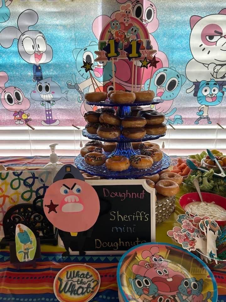 a table topped with lots of donuts covered in frosting