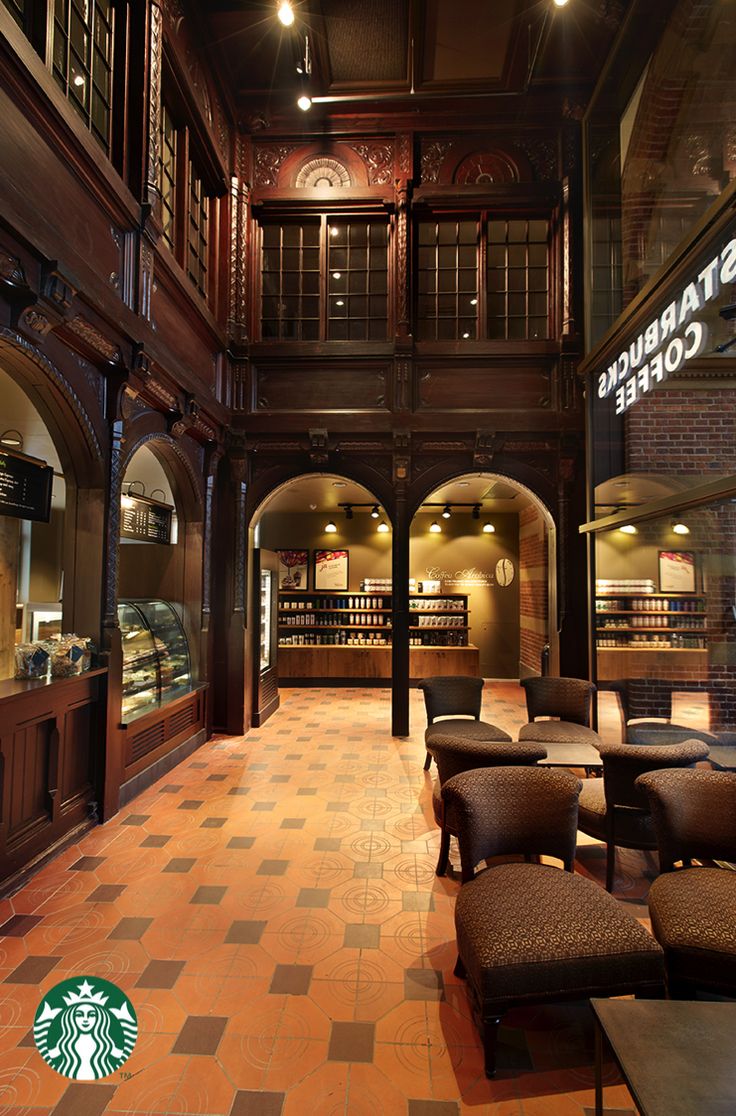 the inside of a starbucks coffee shop with tables and chairs