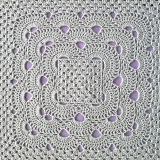 a crocheted doily with purple hearts on it