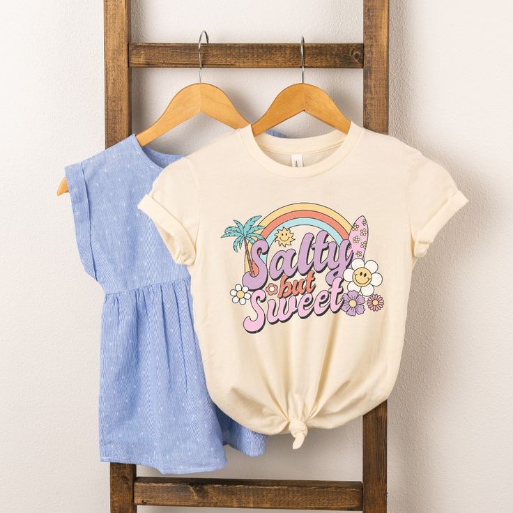 Looking for a cute tee for your kids? We have the perfect Salty But Sweet graphic tee addition to their closet! Sweet Style T-shirt With Funny Print For Spring, Sweet Summer T-shirt With Letter Print, Summer Sweet T-shirt With Letter Print, Cute Spring Letter Print T-shirt, Cute Funny Print T-shirt, Sweet Cotton T-shirt With Funny Print, Sweet Cotton T-shirt With Graphic Print, Sweet Style Crew Neck T-shirt With Cartoon Print, Sweet Cartoon Print Crew Neck T-shirt