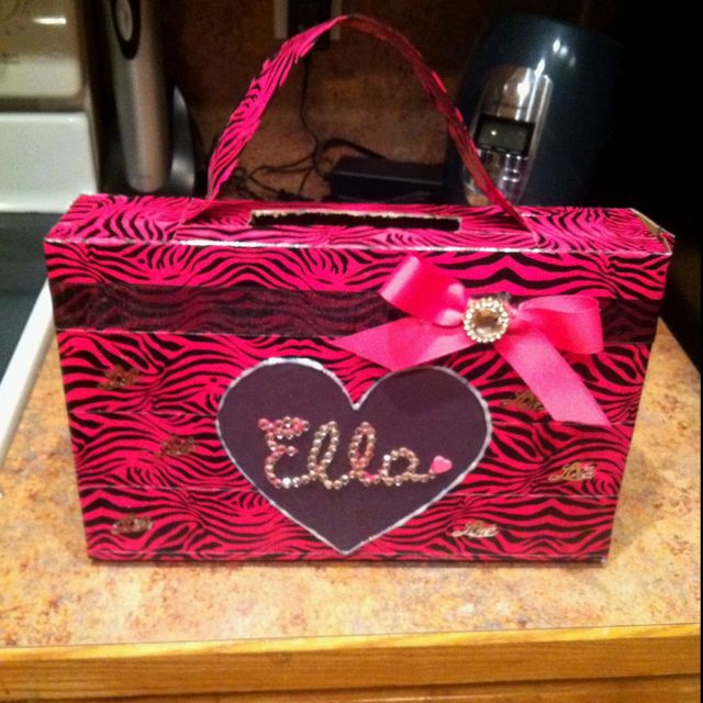 a pink and black zebra print box with a heart on the front that says ello