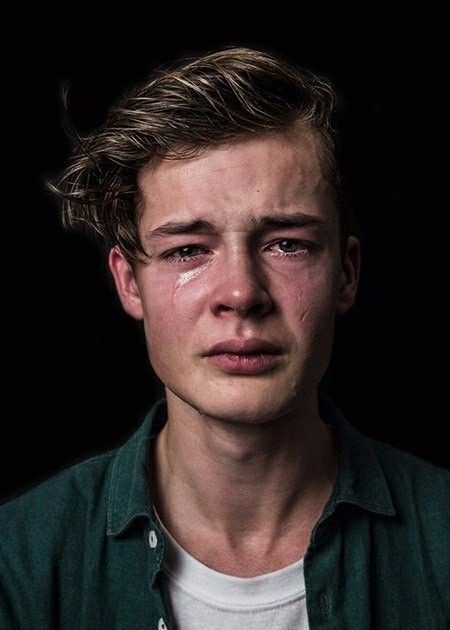 a young man with tears on his face