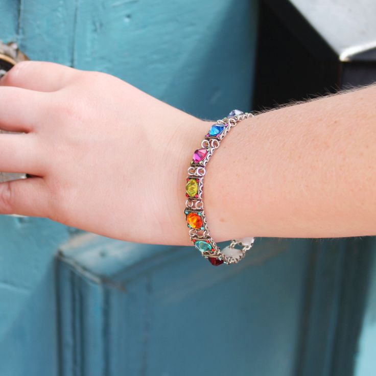 This multi-colored Firefly Rainbow Halley Bracelet is sure to adorn your wrist with a rainbow of delight. This bracelet is a beautiful blend of a contemporary color scheme paired with a classical elegance. Featuring European crystals and Czech glass, this design contains several square charms that are inlaid with a bright gem of some sort. The sparkling pieces, which is most of this bracelet, are sure to catch the light in the most dazzling way. The photos do not do the luminescence justice. You could pair this with other bracelets, but it can totally stand on its own for a moment in the spotlight. Collection: Rainbow Color: Multi-color European crystals, Czech glass Approximately 8 inches long, including a 1.25 inch extender chain Chain is silver-plated antiqued steel Bezel is silver-plat Multicolor Gemstone Tennis Bracelet As A Gift, Multicolor Gemstone Tennis Bracelet As Gift, Multicolor Multi-stone Tennis Bracelet As Gift, Elegant Multicolor Tennis Bracelet As A Gift, Multicolor Jewelry With Jubilee Bracelet For Gift, Multicolor Jubilee Bracelet Jewelry As Gift, Elegant Rainbow Colored Bangle Jewelry, Multicolor Jubilee Bracelet Jewelry For Gift, Elegant Multicolor Bangle Tennis Bracelet