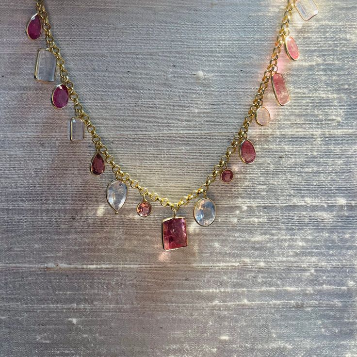 "Featuring 9 carats of  natural and earthmined tourmaline , and 10 carats of natural pink kunzite. The gems are set in a multi shape design, alternating in bezel settings dangling from a 14K yellow gold rolo chain. The gems span 7.5\" long, and the necklace is 16\" around. The heart is .75x.50\" , weighing 9 carats in total A one of a kind piece Marked 14K 10.2g" Luxury Multi-stone Pink Gemstones, Luxury Pink Multi-stone Gemstones, Gold Multi-stone Pink Sapphire Jewelry, Gold Jewelry With Multi-stone Pink Sapphire, Gold Multi-stone Jewelry With Pink Sapphire, Pink Sapphire Multi-stone Gold Jewelry, Exquisite Pink Sapphire Jewelry, Pink Sapphire Multi-stone Jewelry For Gifts, Multi-stone Pink Sapphire Jewelry For Gifts