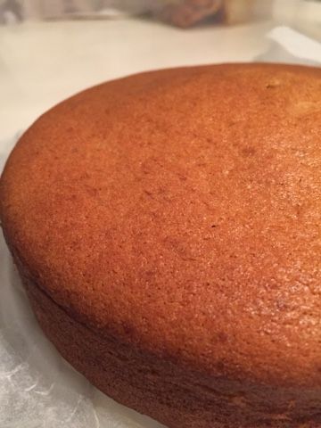 a round cake sitting on top of wax paper