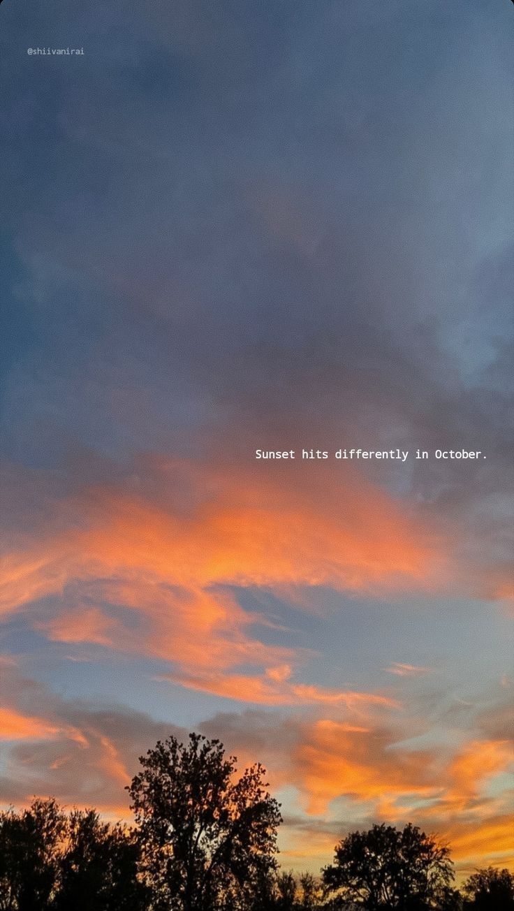 an orange and blue sky with some trees in the foreground that says, sunset never differently in october