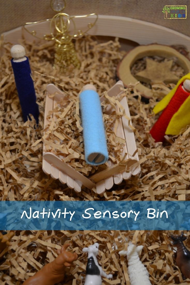 nativity sensory bin filled with toys and wood shavings