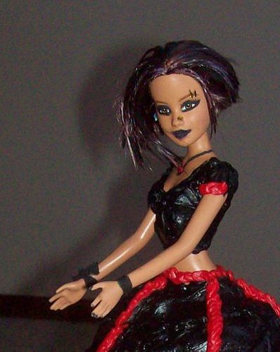 a doll is dressed in black and red