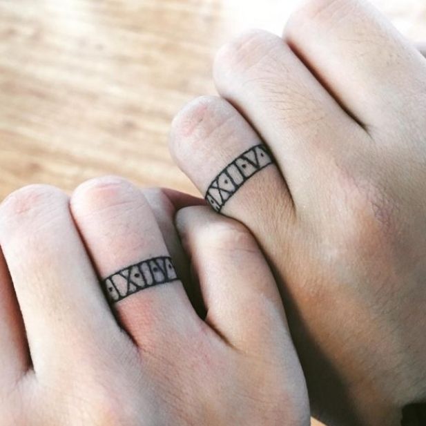 two people with matching rings on their fingers holding each other's hands and the words kiss me written across them