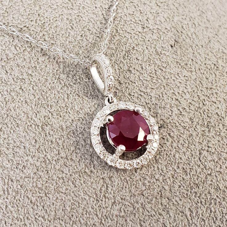 "Ruby & Diamond Halo Pendant!! 14k White Gold pendant is featuring a 6.83mm Round Genuine Red Ruby (1.67ct), with a sparkling Halo of .28ct in Genuine Diamonds surrounding this BEAUTIFUL BRIGHT RED RUBY! Clean, Classic, and strong, this timeless beauty will never go out of style. The chain in the photos is included. It is a 14k white Gold loose pendant rope style chain, and 18\" in length. **Ruby is the official July Birthstone** **Diamond is the official April Birthstone** **Please feel fre Brilliant Cut Ruby Gemstones Fine Jewelry, Elegant Red Diamond Gemstones, Brilliant Cut Ruby Gemstones For Fine Jewelry, White Gold Round Ruby Gemstones, Red Diamond Fine Jewelry Gemstones, Ruby Necklace With Brilliant Cut, Red Diamond Gemstones For Fine Jewelry, Fine Jewelry Red Diamond Gemstones, Brilliant Cut Ruby Necklace In Round Shape