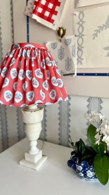 a red and white lamp sitting on top of a table