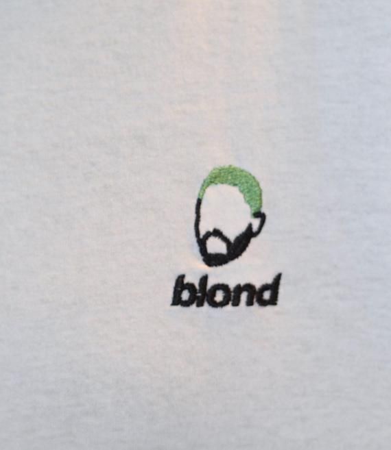 a white shirt with the word blond on it and a green headphone in front