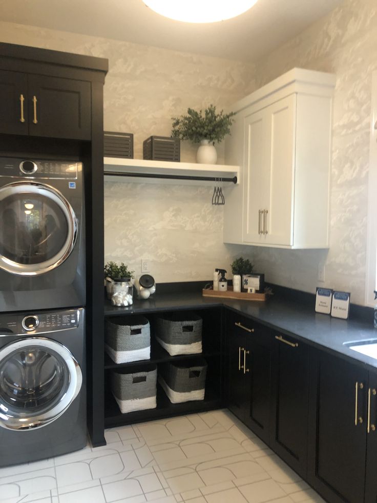 a washer and dryer sitting in a kitchen next to each other on top of cabinets