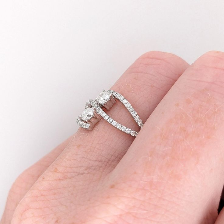 This dual diamond ring features a gorgeous a unique bypass design with natural earth mined diamonds set in solid 14K gold. This two stone diamond ring ring makes a lovely April birthstone gift for your loved ones! This ring is made with solid 14K Gold and natural Earth mined SI / G-H diamonds. As listed, this ring is ready to ship. If you're interested in purchasing this setting with a different center stone please message us! Bypass Ring With Single Cut Diamonds For Promise, Bypass Open Ring With Single Cut Diamonds For Promise, Fine Jewelry Bypass Ring With Tension Setting For Promise, Bypass Ring With Single Cut Diamonds, Diamond Bypass Ring With Single Cut Diamonds, Diamond White Bypass Ring With Diamond Accents, Diamond White Cubic Zirconia Bypass Promise Ring, Diamond Bypass Ring With Tension Setting, Cubic Zirconia Bypass Ring With Brilliant Cut