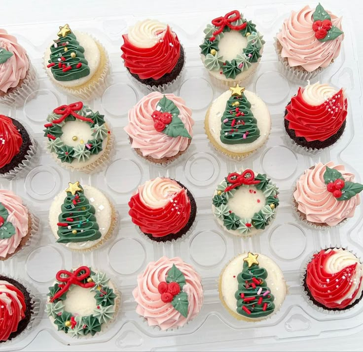 twelve cupcakes decorated with christmas decorations and bows