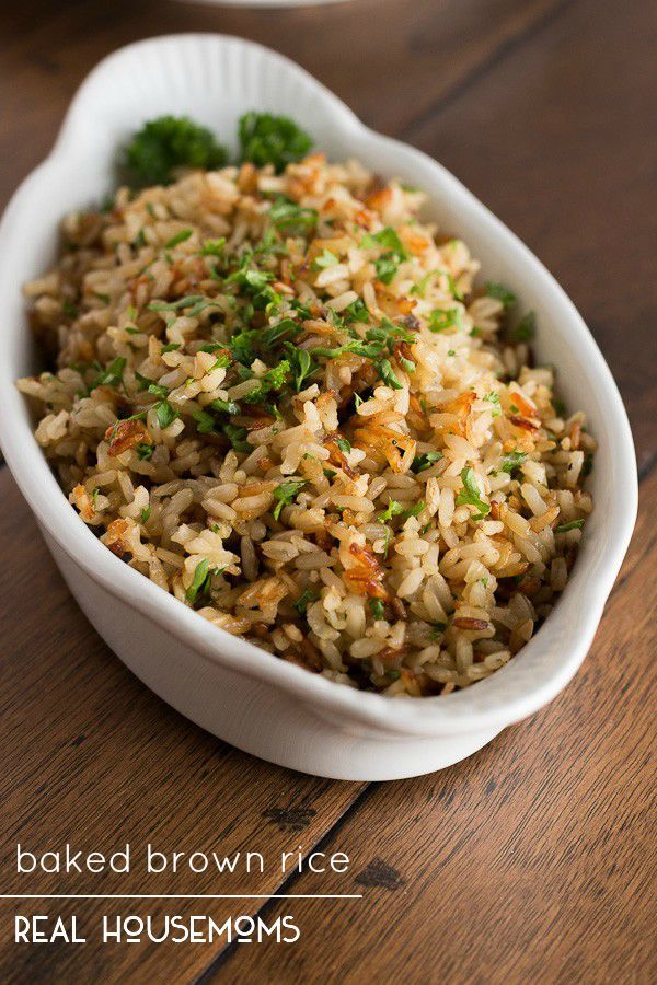 a white bowl filled with rice and broccoli on top of a wooden table