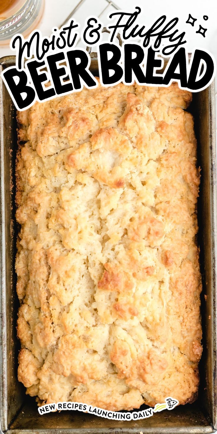 a loaf of beer bread sitting in a pan on top of a white tablecloth