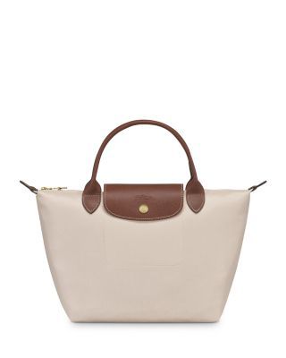 In a miniature size, Longchamp's signature nylon tote lends sophisticated style to every look. The lightweight design folds up for ease during travel. Top Handle Handbags, Nylon Tote, Longchamp Le Pliage, Small Tops, Sophisticated Style, Handbags