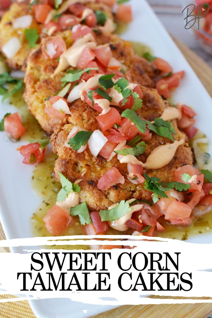 sweet corn tamale cakes on a white plate with tomatoes and cilantro garnish