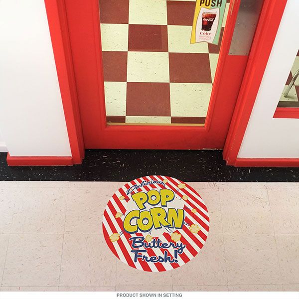 an open sign is on the floor in front of a red and white checkered door