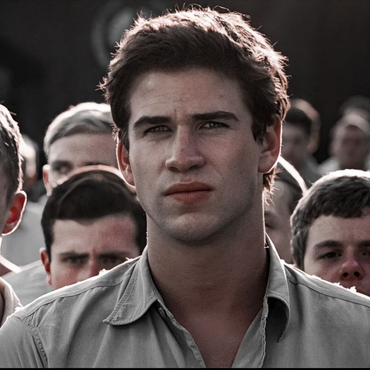 a group of young men standing next to each other in front of a camera man