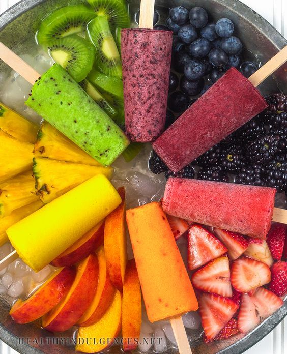 an assortment of fruits and popsicles arranged in a circle