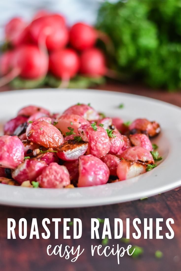 roasted radishes on a white plate with parsley and red peppers in the background