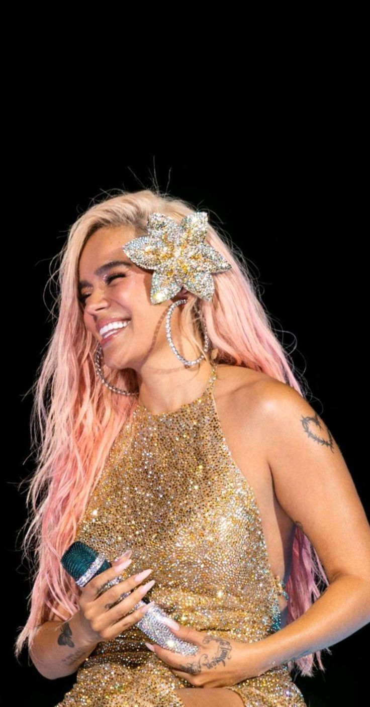 lady with pink hair and gold dress on stage