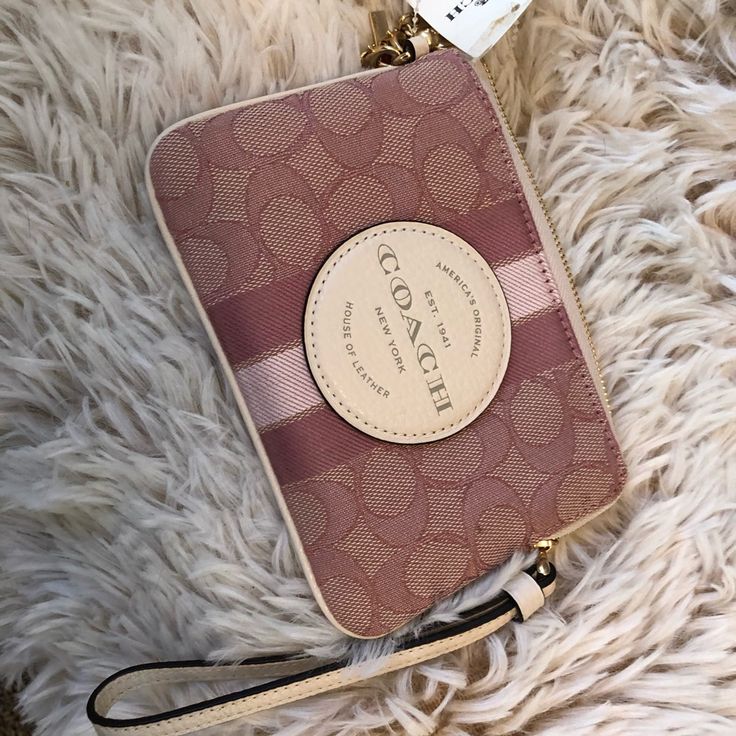 Coach Boxed Dempsey Corner Zip Wristlet In Signature Jacquard With Coach Patch And Stripe. Also Includes Charms. See The Following Description: Signature Jacquard And Refined Pebble Leather Two Credit Card Slots Zip-Top Closure, Fabric Lining Wrist Strap Attached 6 1/4" (L) X 4" (H) X 1/2" (W) Includes Removable Charms Chic Pink Bag With Wrist Strap, Pink Wristlet With Removable Pouch As Gift, Trendy Pink Coach Wallet, Pink Pouch Clutch With Wrist Strap, Pink Pouch Wristlet With Strap, Pink Clutch Wristlet With Zipper Closure, Pink Pouch Wristlet With Wrist Strap, Elegant Pink Coach Clutch, Pink Clutch With Wrist Strap