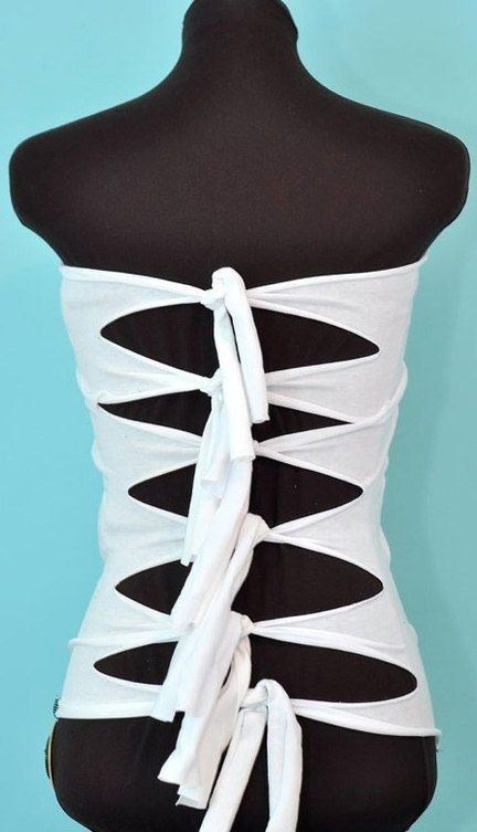 a white corset on a mannequin with black and white ribbons tied around it