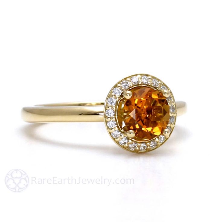 "A beautiful natural Citrine ring with diamonds in your choice of 14K or 18K White, Yellow or Rose Gold. The center stone is a lovely round cut .75ct yellow natural Citrine gemstone. A halo of conflict free diamonds surround the center stone. The setting has a lovely fleur de lis design and a classic, comfortable plain shank. Citrine is the birthstone for November. Made to order. Please allow three to four weeks for delivery. ABOUT THIS RING Shown on Ring Size 7 Finger Composition: 14K or 18K Go Citrine Diamond Ring In Yellow Gold For Anniversary, Yellow Gold Citrine Diamond Ring For Anniversary, Anniversary Yellow Gold Citrine Diamond Ring, Yellow Gold Topaz Ring With Halo Design For Anniversary, Yellow Halo Ring For Anniversary, Yellow Sapphire Diamond Ring For Anniversary, Yellow Sapphire Rings With Halo Setting For Anniversary, Orange Rings With Halo Setting For Anniversary, Anniversary Yellow Sapphire Ring With Halo Setting