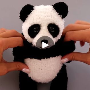 a stuffed panda bear being held by two hands with the caption's video below it