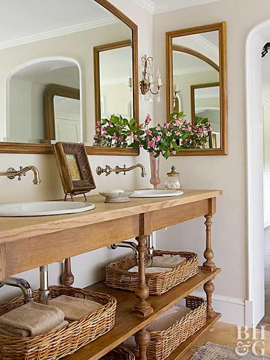 a bathroom with two sinks, mirrors and baskets on the counter in front of it