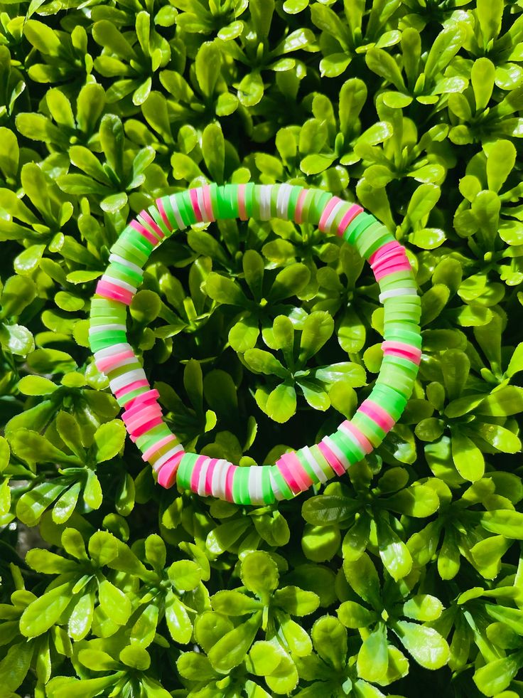 A pink, green, and white clay bead bracelet that is unique but also simple enough to wear with any outfit! *All bracelets are 6.5 - 7 inches, but if custom size is needed, please leave a message or add a note*   You can also mix and match with other bracelets from my shop to create a bracelet stack that suits your style:) All bracelets are.... --------------------------- - Comfortable  - Durable - Stretchy - Colorful - Waterproof ---------------------------- Please contact me at baforsyt11@gmail.com if bracelets arrive damaged or is too small/big. Also feel free to contact me if you would like a custom size, colors, design, or name added to the bracelet:) ( no extra charge )  CARE TIPS ----------------------------------------------------------- - Roll or lightly stretch to get of wrist - D Handmade Green Heishi Beads Bracelets, Green Fun Friendship Bracelets With Colorful Beads, Fun Green Friendship Bracelets With Colorful Beads, Fun Green Stretch Bracelet For Friendship, Fun Green Friendship Bracelet With Colorful Beads, Fun Green Stretch Bracelet With Letter Beads, Green Stretch Bracelet With Letter Beads In Fun Style, Fun Green Beaded Stretch Bracelet, Green Heishi Beads Stretch Bracelet With Colorful Beads