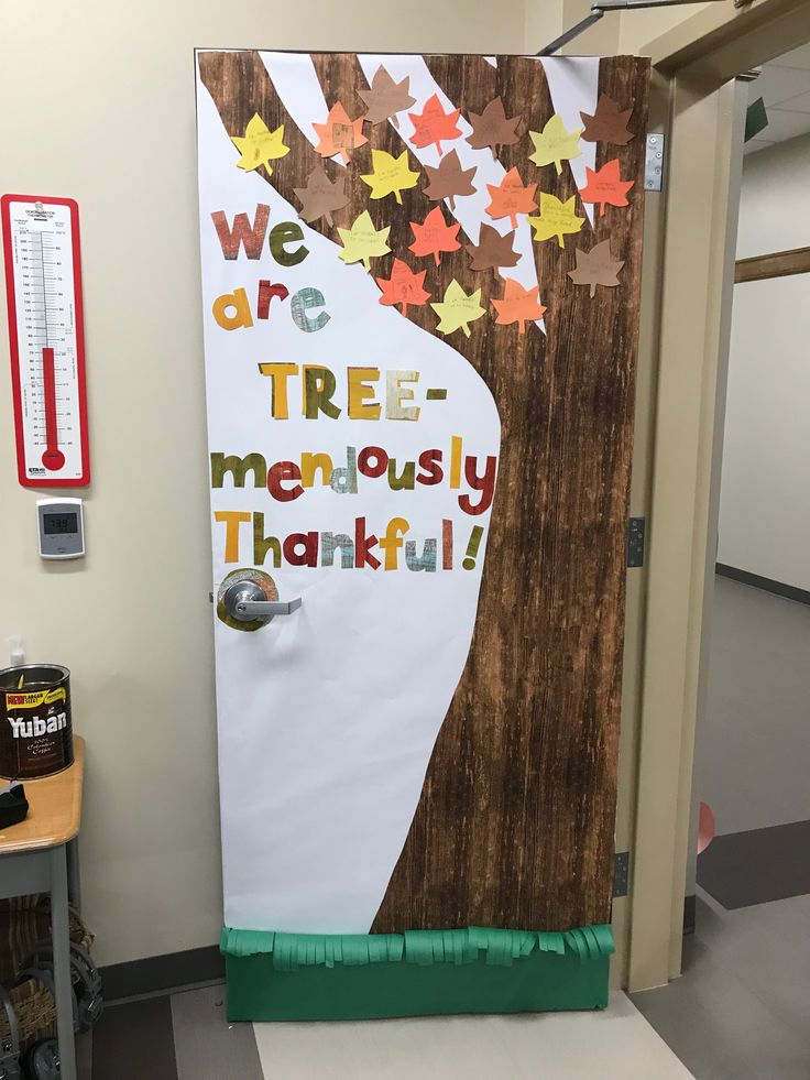 a classroom door decorated with fall leaves and the words, we are tree menusly grateful