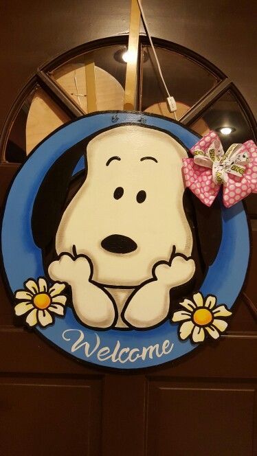 a welcome sign with a snoopy dog on it's face and a pink bow