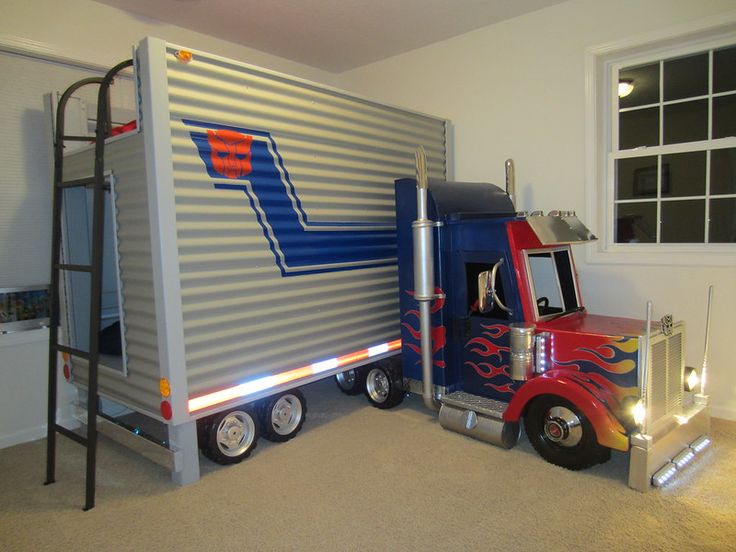 a bed that is made to look like a semi - truck in a room with a ladder