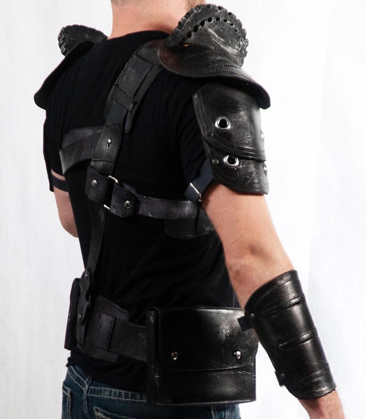 a man in black leather armor with his back to the camera