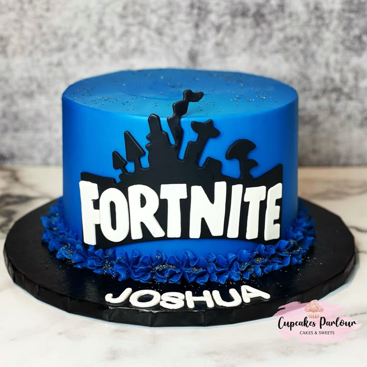 a blue and black cake with the word fortnite on it's side