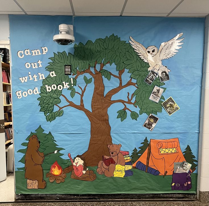 a classroom door decorated with an image of a tree and camping animals on the outside