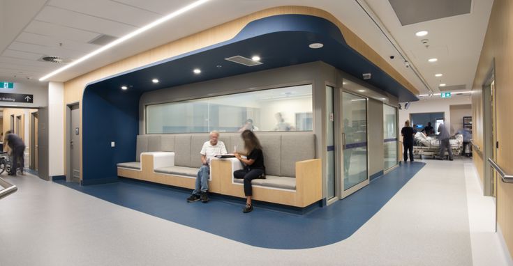 a person sitting on a bench in a hospital waiting room