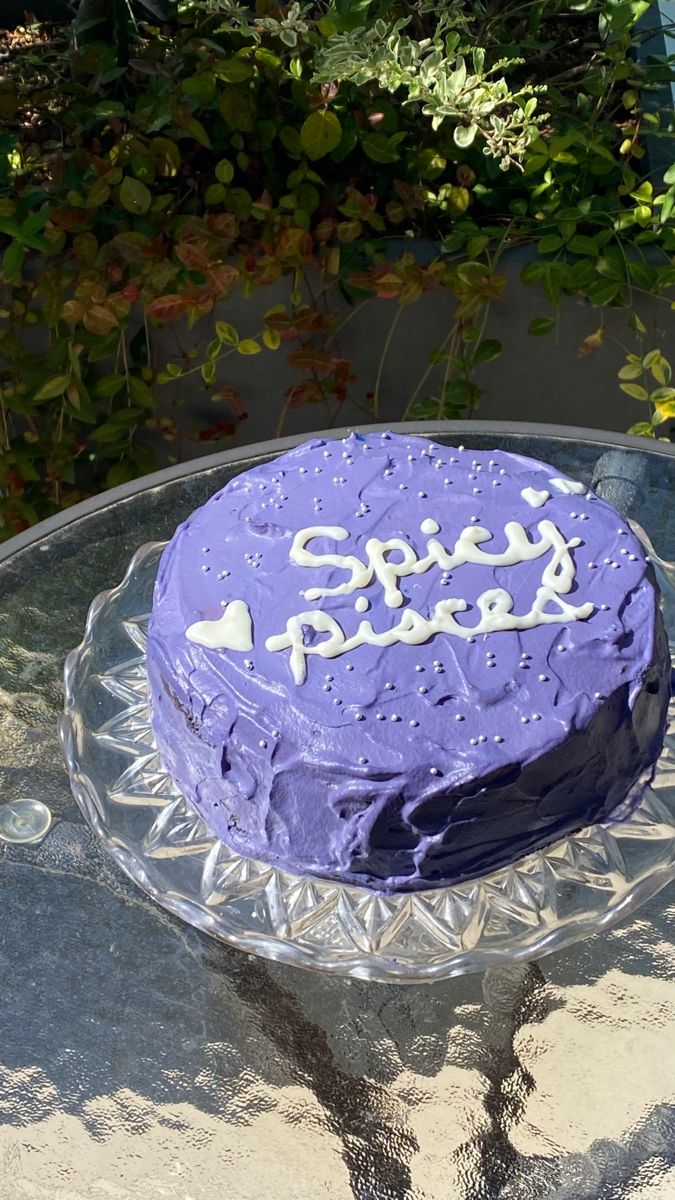 a purple cake sitting on top of a glass plate