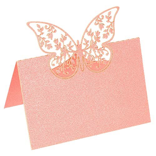 a pink card with a butterfly cut out of it's back and gold foil on top