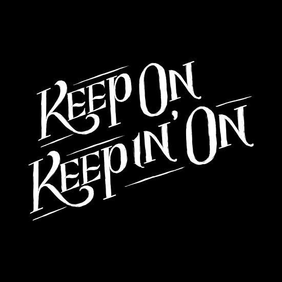 the words keep on repin'on written in black and white ink, against a dark background