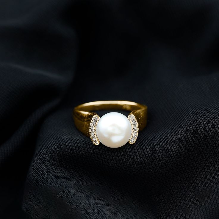 Product Details It is a Gold Ring consisting of a Round Shape Freshwater Pearl as Solitaire with Round Shape Diamond gemstones as Accent. It is an Engagement Ring for Women. Product Information SKU SHP-RINGS022150274 Width 10.6 mm Height 10 mm Weight 3.82 gm (Approximate) FRESHWATER PEARL INFORMATION No.of Stones 1 Pieces Total Weight 8.00 Carat (Approximate) Dimension(approx) Round-10X10 mm-1 Pcs Color White Cut Brilliant Shape Round Setting Type Collar Quality Grade AAA DIAMOND INFORMATION No.of Stones 10 Pieces Total Weight 0.30 Carat (Approximate) Dimension(approx) Round-1.60X1.60 mm-10 Pcs Color HI Cut Brilliant Shape Round Setting Type Collar Quality Grade SI View More Product Parent Collection Handle pearl-rings Pearl Rings In Gold For Women, Diamond And Pearl Engagement Ring, Skater Jewelry, Pearl And Diamond Engagement Ring, Pearl Ring Design, Pearl Ring Simple, Pearl Jewelery, Diamond Collar, White Pearl Ring