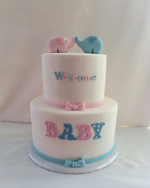 a baby shower cake with two elephants on top and the words welcome baby written in blue