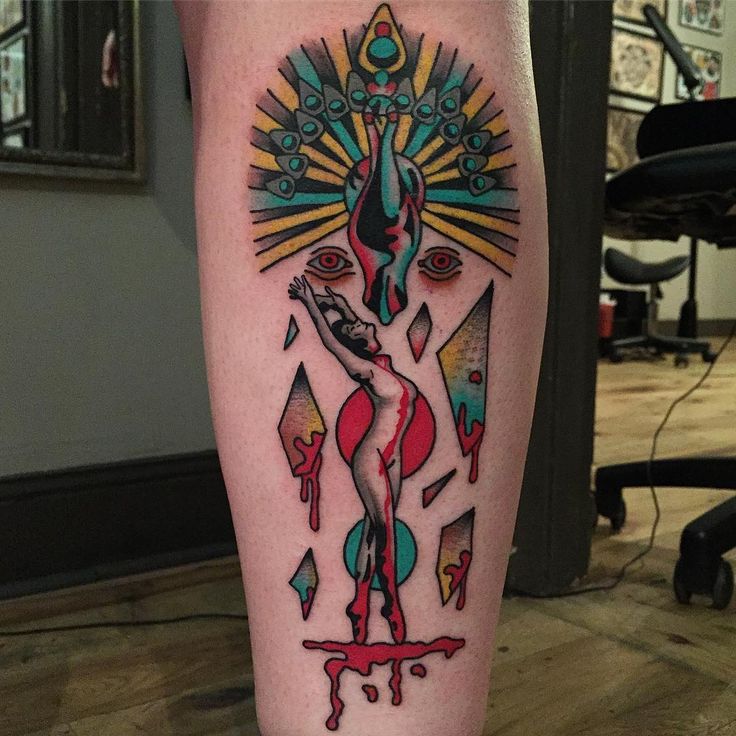 a tattoo on the leg of a woman with an abstract design and colorful paint drips