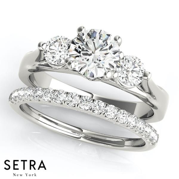 three stone engagement ring set with matching wedding band in 18k white gold, featuring round brilliant cut diamonds