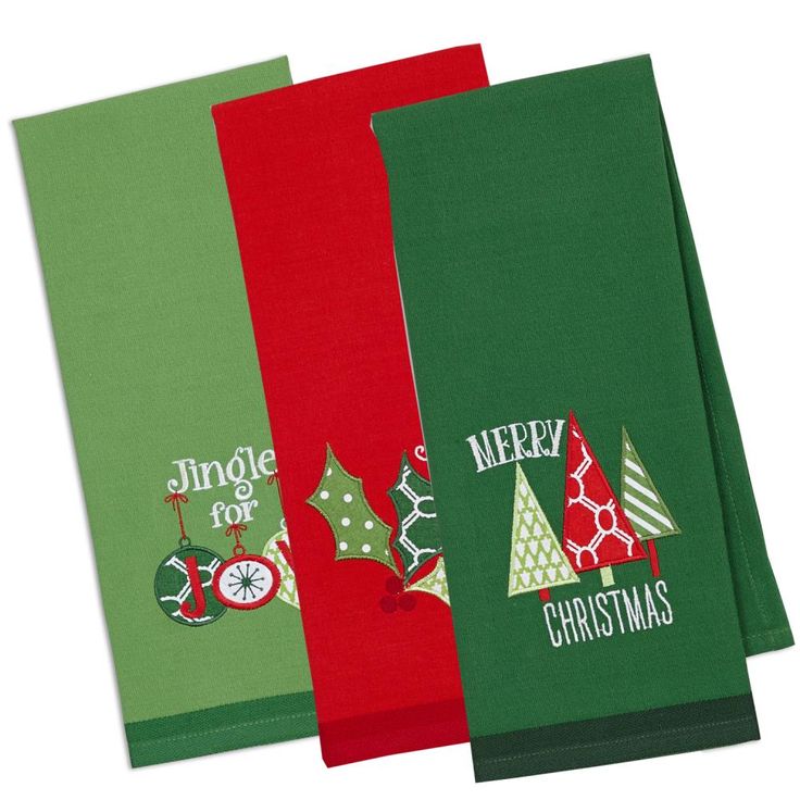 three christmas napkins with holiday designs on them