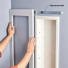 a man is holding the door to an empty cabinet with screws and nails on it